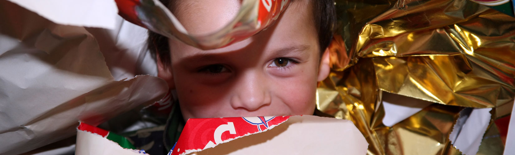 hero-how-to-recycle-holiday-packaging-child-hiding-paper-blog