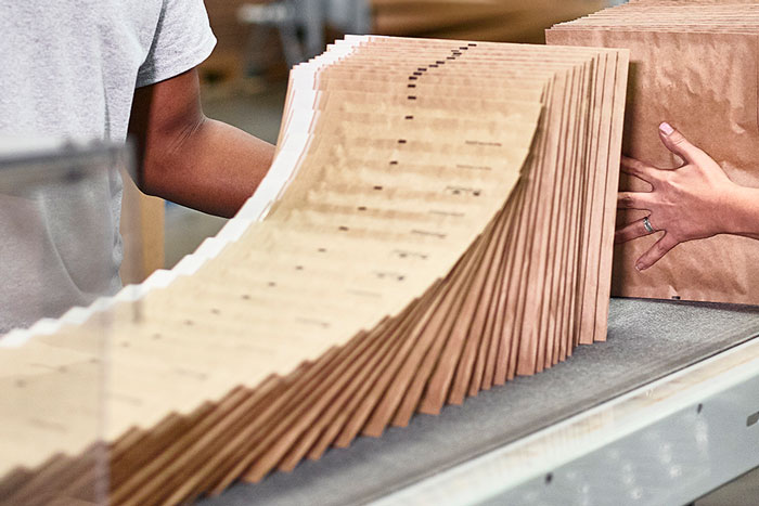 bundle of evertec mailers on top of conveyer belt