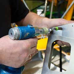 close up image of person fixing metal panel