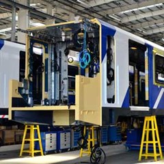 blue modern train being serviced