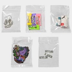Image of five transparent multipurpose poly bags holding small items such as candy, cards, stickers, and metal clips, showcasing their use for organization and storage.