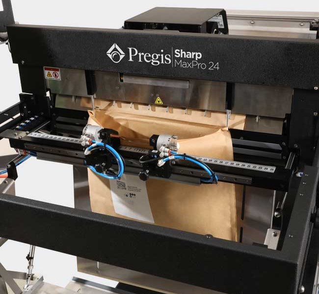 Image of a Pregis Sharp MaxPro 24 bagging machine with an Evertec Mailer in process.