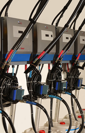 A couple of foam in place machines set up on a wall.