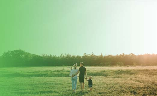 Happy family walking on field